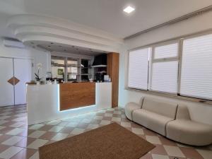 a living room with a couch and a counter at Hotel Rivabella in Davoli