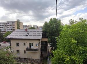 a building with a gray roof in a city at Cozy room with a balcony in Sarajevo