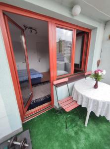 a room with a table and a room with a bedroom at Cozy room with a balcony in Sarajevo