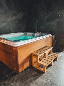 a wooden bath tub with a blue pool at Wellness Baška in Baška