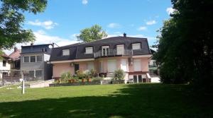 a large house with a lawn in front of it at Vila Jasmina in Bihać