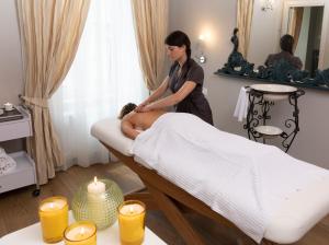 a woman sitting on a bed in a room at Hotel Leon D'Oro in Orta San Giulio +40 photos