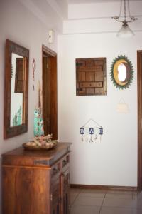 a room with a wooden dresser and a mirror at Andros Melissari in Koumárion