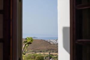 a view of a mountain from a window at Andros Melissari in Koumárion