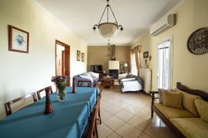 a living room with a blue table and a couch at Andros Melissari in Koumárion