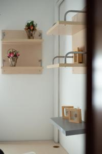 a room with shelves and a table with flowers at Andros Melissari in Koumárion