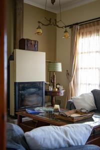 a living room with a couch and a coffee table at Andros Melissari in Koumárion