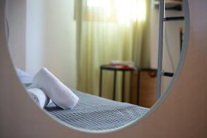 a mirror reflection of a bed in a room at Andros Melissari in Koumárion