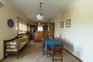 a living room with a table and a couch at Andros Melissari in Koumárion
