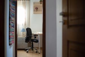 a room with a desk and a chair in a room at Andros Melissari in Koumárion