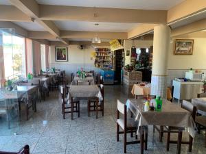 a restaurant with tables and chairs in a room at Hotel Dom Daniel in Palmares