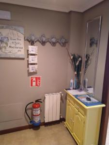 a kitchen with a yellow cabinet and a fire extinguisher at Apartamento Maria in Santoña