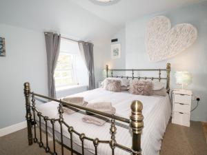 a bedroom with a bed with a large heart on the wall at 2 Cliff Cottages in Truro