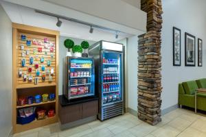 a grocery store with a refrigerator in a room at Holiday Inn Express & Suites Wheat Ridge-Denver West, an IHG Hotel in Wheat Ridge