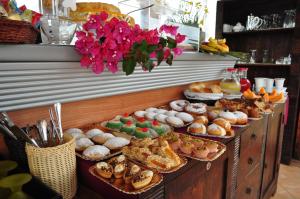 a buffet with many different types of bread and pastries at Rooms and Breakfast Zefiro in San Vito lo Capo