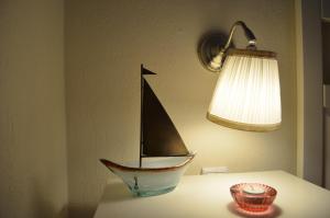 a toy boat sitting on a table with a lamp at Liogerma apartments in Ierissos