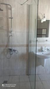 a bathroom with a shower and a sink at Riverside villas in Ortaca