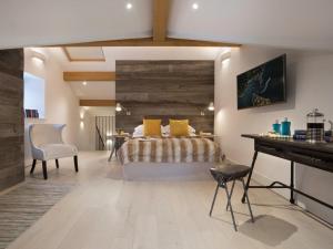 a bedroom with a bed with yellow pillows and a desk at Shepherd's View in Kendal +15 photos