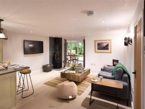 a living room with a couch and a table at Shepherd's View in Kendal