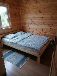 a bedroom with two beds in a wooden cabin at Domek nad morzem in Zastań