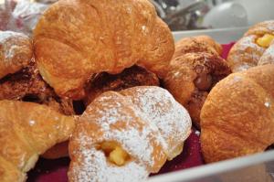 a bunch of donuts with powdered sugar on them at Rooms and Breakfast Zefiro in San Vito lo Capo