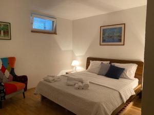 a bedroom with a bed with towels on it at Villa Mediterranea in Murter