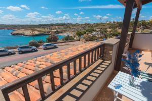 a balcony with a view of a road and the ocean at L'Ancora Blu in Porto Torres