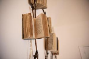 a lamp with an open book on top of it at La casa sulla piazza (Historic apartment) in Enna