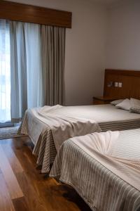 Una cama o camas en una habitación de Hotel Comodoro