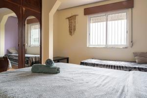 a bedroom with a bed with a stuffed animal on it at Natural Mystic Hostel in Costa da Caparica