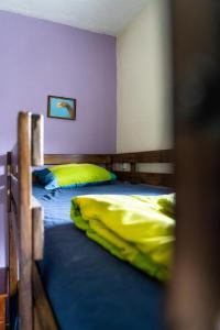 a bedroom with two bunk beds with yellow sheets at Natural Mystic Hostel in Costa da Caparica