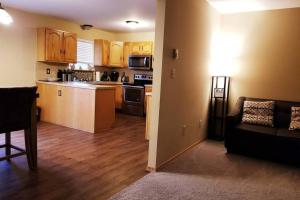 a living room with a couch and a kitchen at *Amenity-Filled Waterfront Oasis @Saw Creek Estates Near WaterFalls and Hiking* in East Stroudsburg