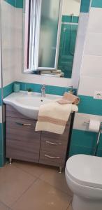 a bathroom with a sink and a toilet and a mirror at casa anna in Vico Equense
