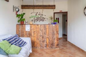 a living room with a wooden partition and a couch at Natural Mystic Hostel in Costa da Caparica