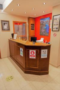a lobby with a reception desk in a building at Don Pepe Hotel y Cabañas in El Calafate