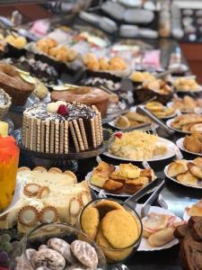 a table filled with lots of different types of pastries at Buriti Hotel in Jataí