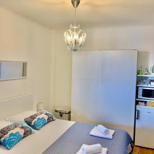 a room with a bed and a chandelier at Apartment and room Sveti Jakov in Dubrovnik