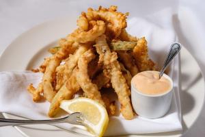 a plate of french fries and a cup of dipping sauce at Wyndham Moline on John Deere Commons in Moline