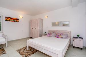 Postel nebo postele na pokoji v ubytování Apartmani LIRA