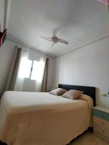 a bedroom with a bed with a ceiling fan at Park Beach La Mata in La Mata
