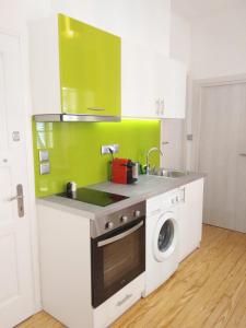 a kitchen with a sink and a washing machine at Corfu Mariú Suite by Liston in Corfu