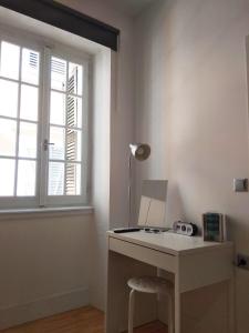 a white desk with a lamp and a window at Corfu Mariú Suite by Liston in Corfu