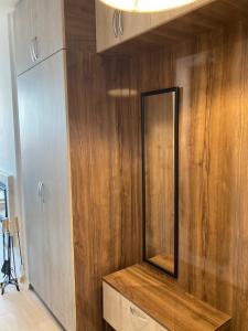 a bathroom with a mirror on a wooden wall at Mirabell Studio Bansko - Amazing view & fireplace in Bansko