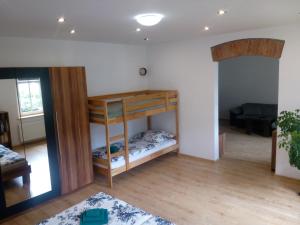 a room with two bunk beds and a couch at Apartmán Albreit 1 in Jáchymov