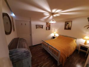 a bedroom with a bed and a table and two lamps at Les Chambres Chouettes in Villefranche-de-Conflent