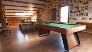 a room with a pool table in the middle of it at LA POSADA DEL ISABENA in Roda de Isábena