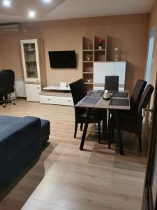 a living room with a dining room table and chairs at Apartman Lovro in Rijeka