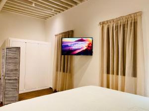 a bedroom with a bed and a tv on the wall at Rhodes Old Town Harmony Suite in Rhodes Town