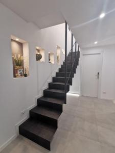 a staircase in a house with a black stair case at Catania Castle affittacamere di Amato G in Catania