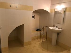 a bathroom with a sink and a toilet and a mirror at Landolina Palace Hotel in Noto +74 photos